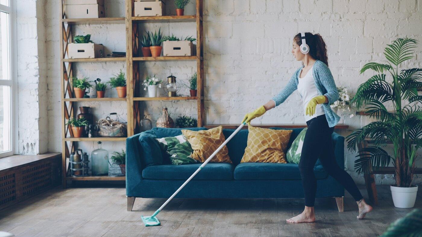 Cleaner mopping a wooden floor